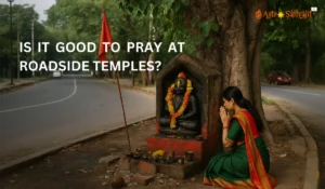 Roadside shrine with idol and offerings at a busy T-junction, symbolizing Vastu imbalance and hidden spiritual dangers.