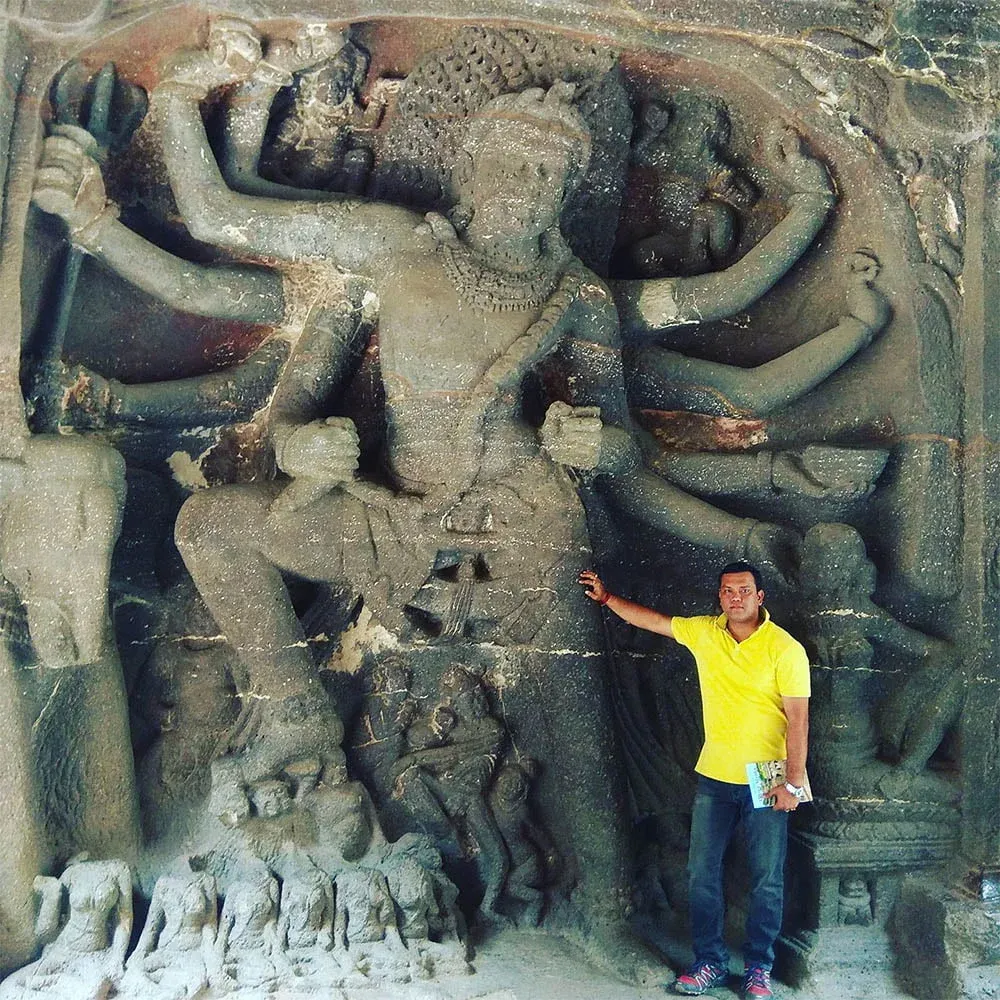 Astrologer Sailyajit Baruah with the idol of Devi Durga