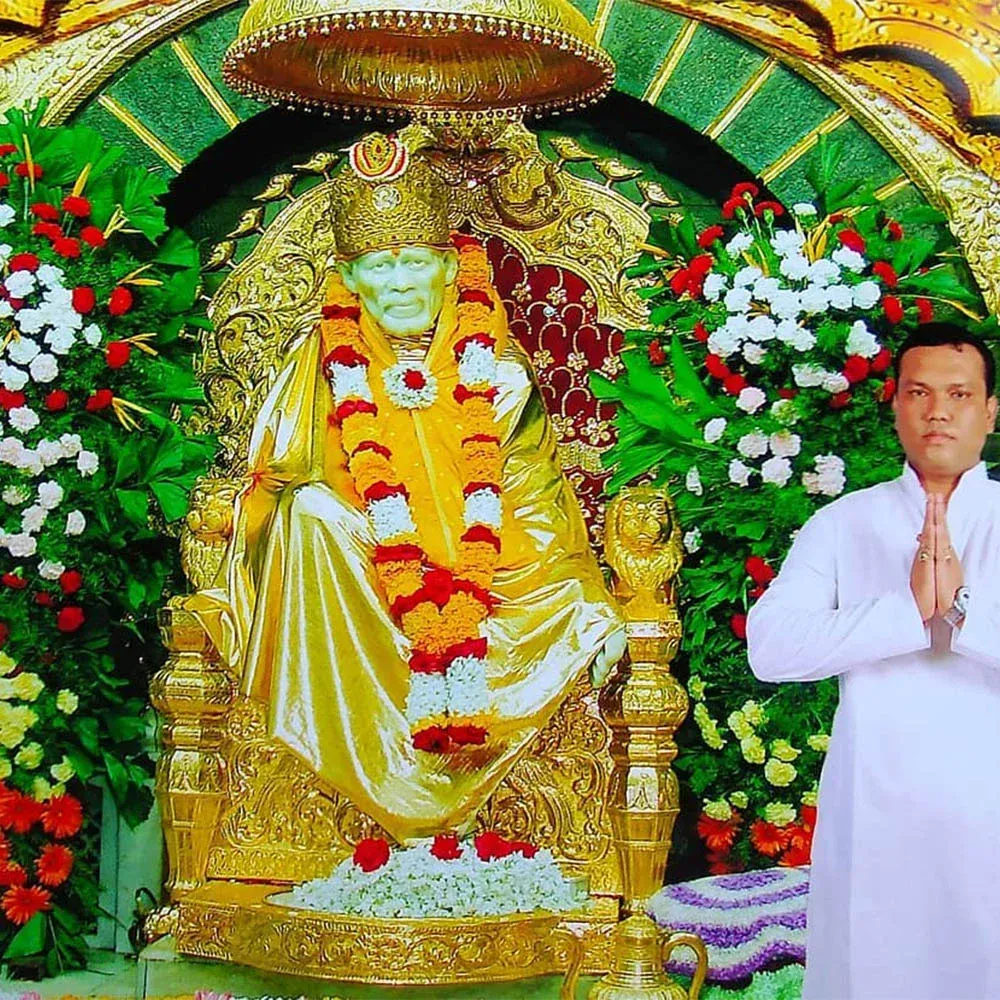 Astrologer Sailyajit Baruah with the idol of Sai Baba